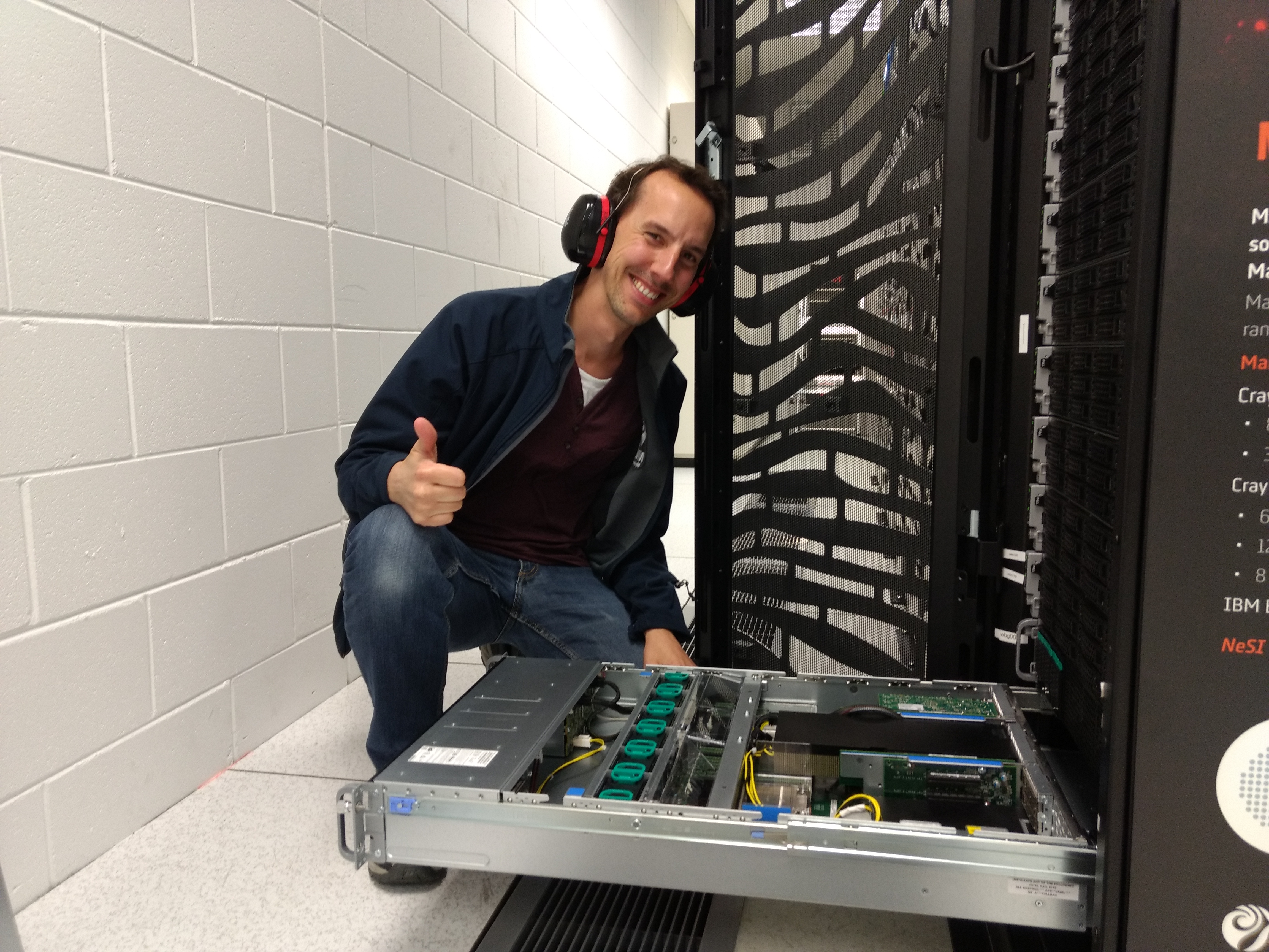 NeSI Data Engineer Maxime Rio pictured next to the Mahuika rack with the A100s cards installed.