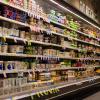 Photo of stocked shelves of the dairy section of a supermarket.