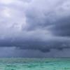 Picutre of dark clouds on the horizon of an ocean. Image by Luda Kot from Pixabay.
