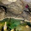 A picture of someone sitting in a cave in French Polynesia.